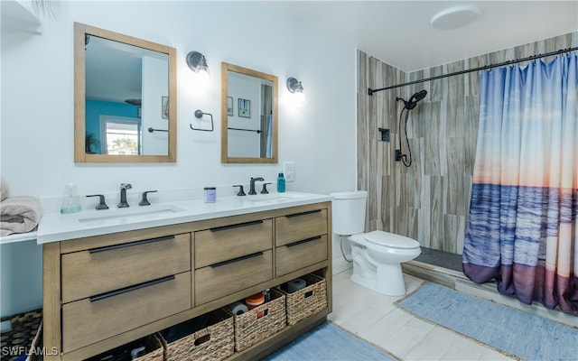 bathroom featuring curtained shower, vanity, and toilet