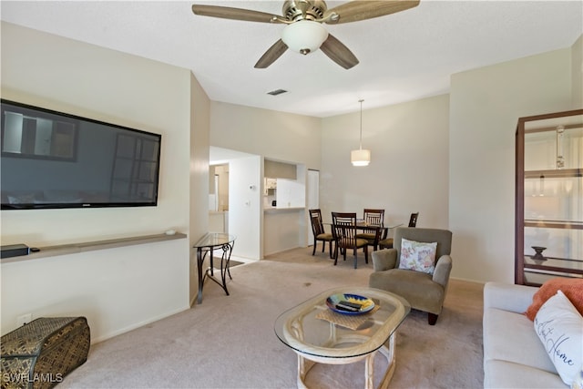 carpeted living room featuring ceiling fan