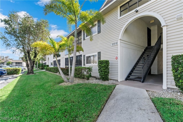 view of side of property with a yard