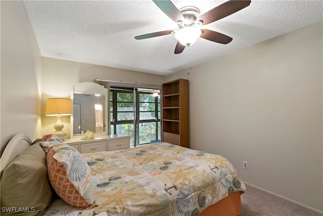 carpeted bedroom featuring a textured ceiling and ceiling fan