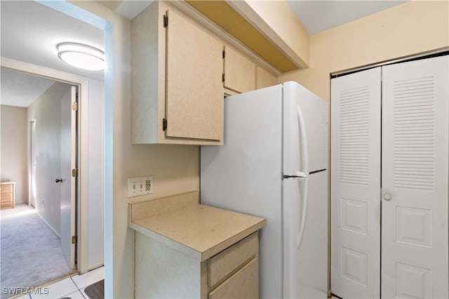 kitchen with light carpet and white fridge