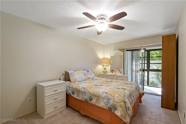 bedroom with light colored carpet, ceiling fan, a textured ceiling, and access to outside