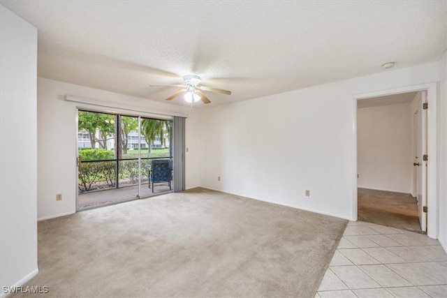 carpeted empty room with a textured ceiling and ceiling fan