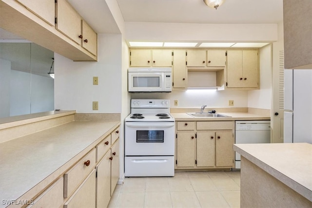 kitchen featuring light tile patterned floors, white appliances, and sink