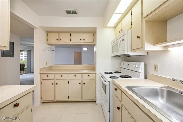 kitchen with white appliances, visible vents, light countertops, cream cabinetry, and a sink