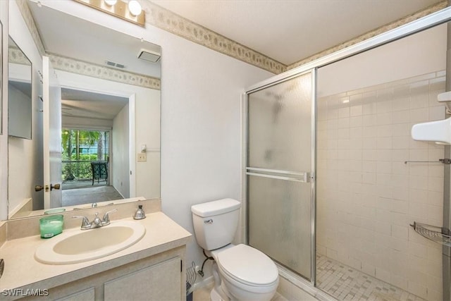 full bathroom featuring a stall shower, visible vents, vanity, and toilet