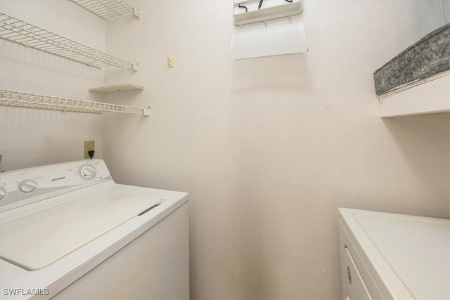 laundry room featuring laundry area and washing machine and clothes dryer