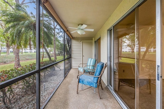 unfurnished sunroom featuring ceiling fan