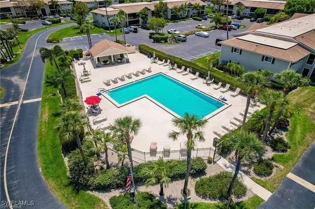 view of swimming pool with a residential view and fence