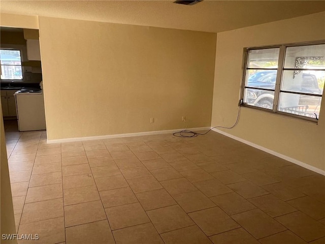 tiled empty room featuring sink