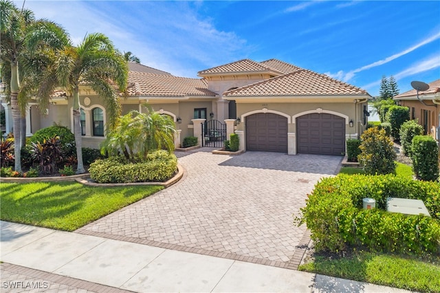 mediterranean / spanish-style home with a garage