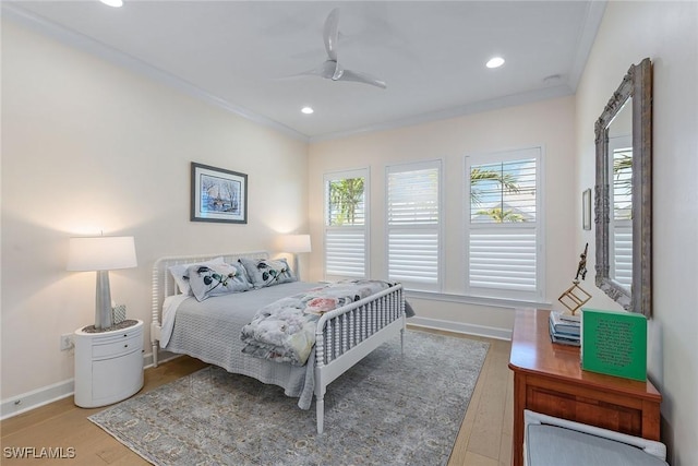 bedroom featuring ceiling fan, wood-type flooring, and ornamental molding