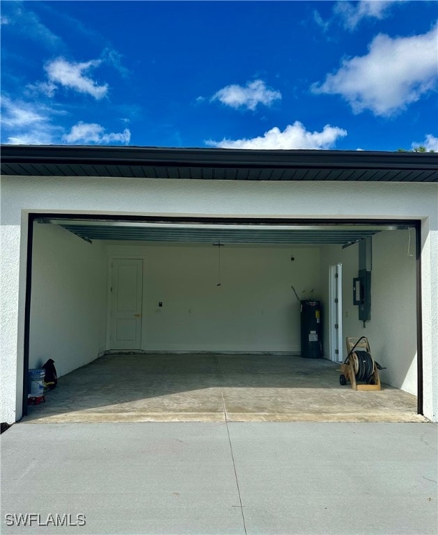 garage with electric panel, a carport, and electric water heater