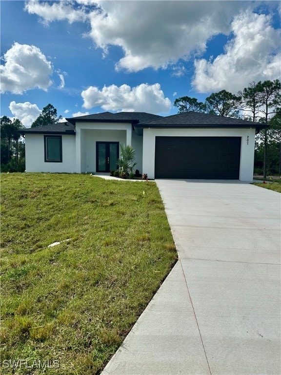 single story home with a garage and a front yard