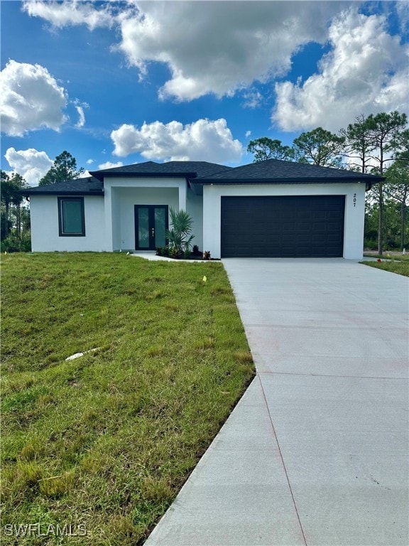 ranch-style home with a front lawn and a garage