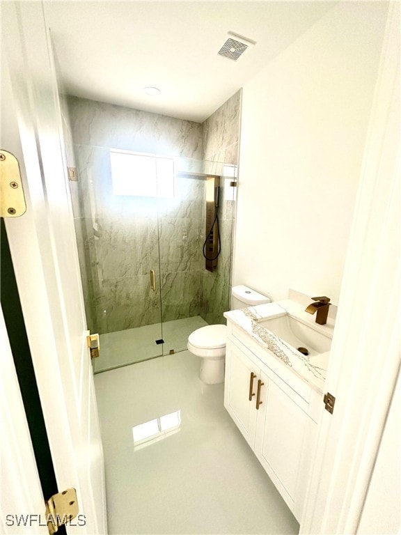 bathroom featuring walk in shower, vanity, and toilet