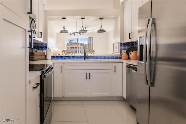 kitchen featuring white cabinetry, stainless steel appliances, and backsplash