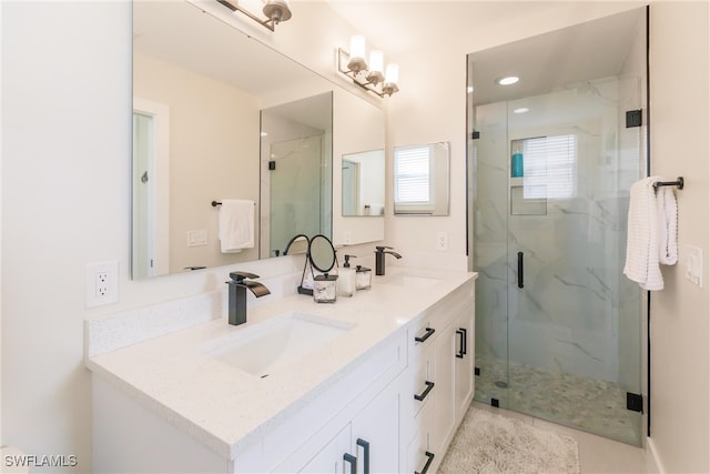 bathroom featuring tile patterned floors, vanity, and a shower with door