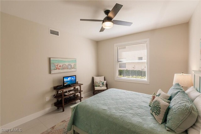 tiled bedroom with ceiling fan