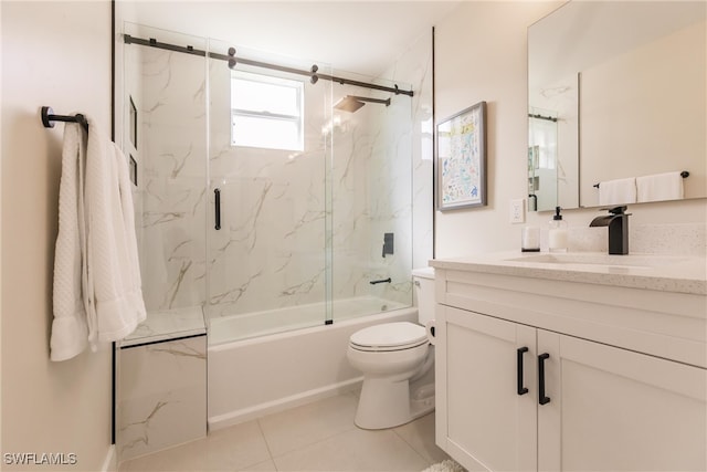 full bathroom with toilet, bath / shower combo with glass door, vanity, and tile patterned floors