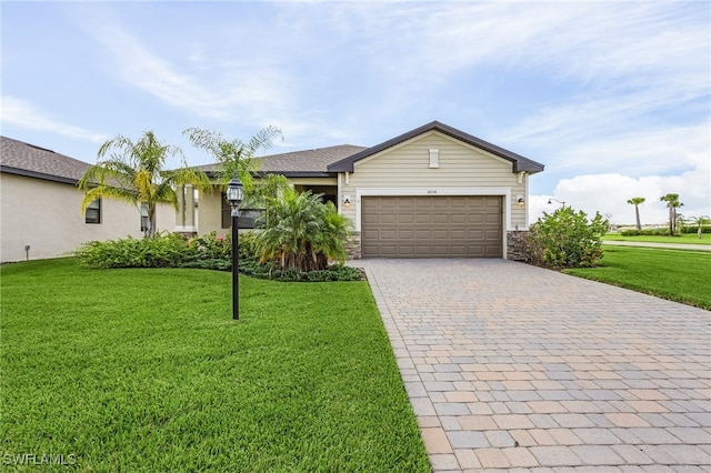 ranch-style home featuring a garage and a front lawn