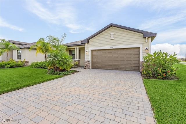 single story home featuring a garage and a front lawn