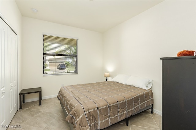 tiled bedroom featuring a closet