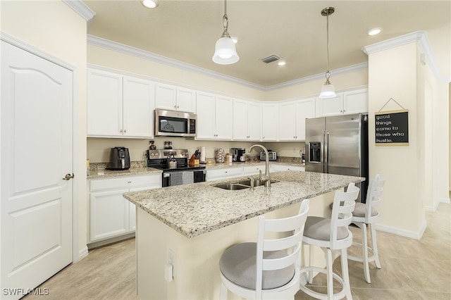 kitchen featuring stainless steel appliances, sink, ornamental molding, a kitchen island with sink, and white cabinets