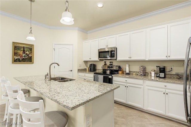 kitchen featuring stainless steel appliances, hanging light fixtures, white cabinetry, and a kitchen island with sink