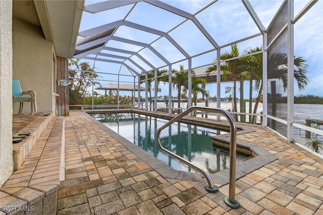 view of pool with a lanai, a water view, and a patio