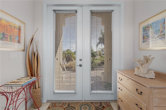 doorway to outside with french doors, a wealth of natural light, and light tile patterned flooring