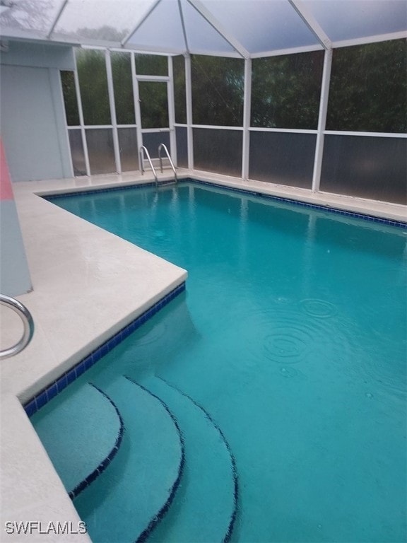 view of pool with a lanai