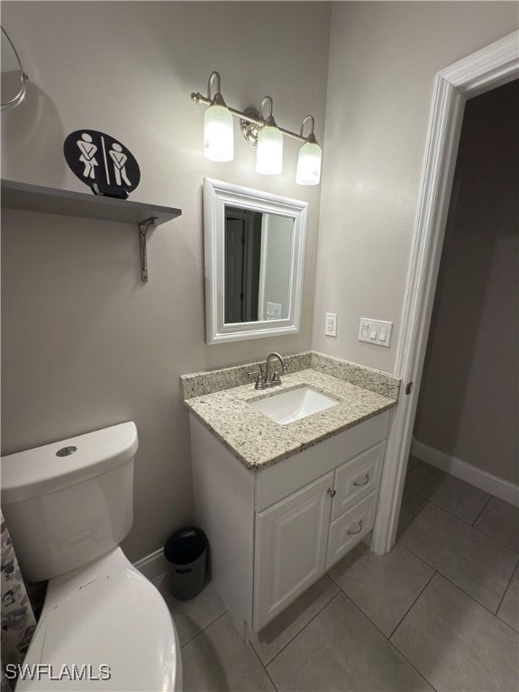 bathroom featuring tile patterned floors, vanity, and toilet