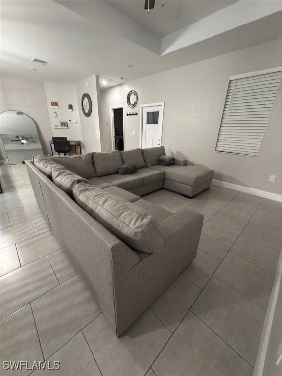 living room with ceiling fan and light tile patterned floors