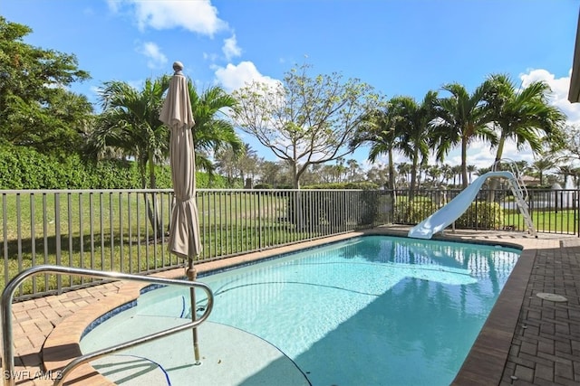 view of swimming pool with a water slide