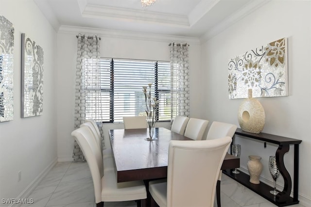 dining area featuring a raised ceiling and crown molding