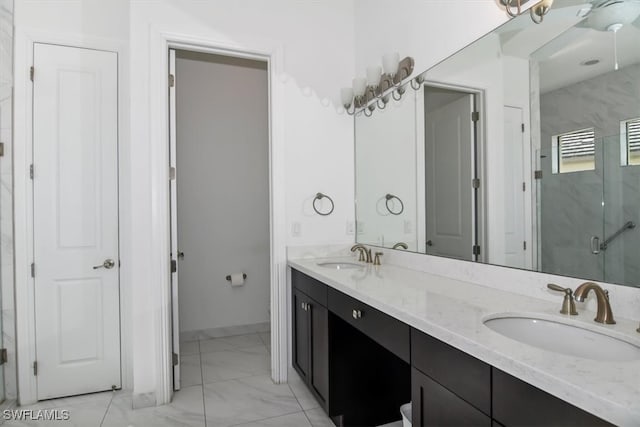 bathroom with vanity and a shower with door