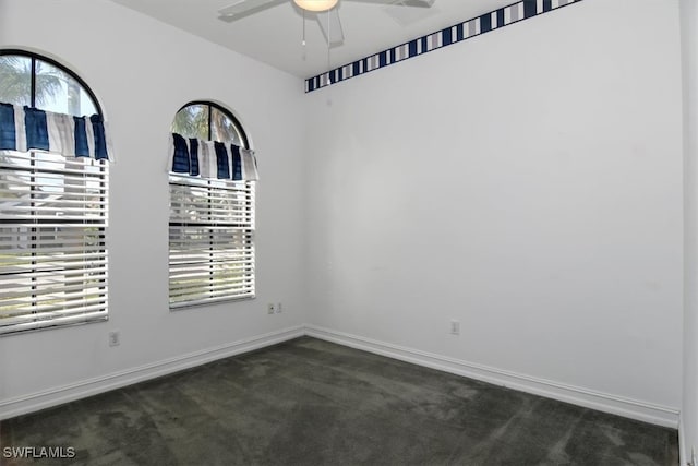 carpeted spare room featuring ceiling fan