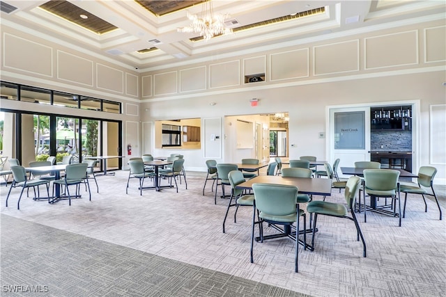 dining area featuring carpet flooring, beam ceiling, a towering ceiling, and coffered ceiling