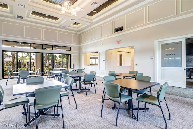 dining area featuring light carpet, coffered ceiling, beam ceiling, a chandelier, and a high ceiling