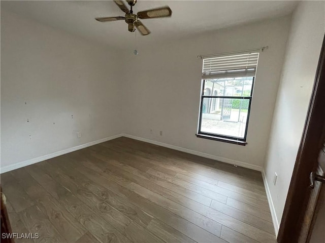 spare room with wood-type flooring and ceiling fan