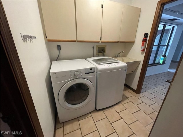 laundry room featuring separate washer and dryer, light tile patterned floors, sink, and cabinets