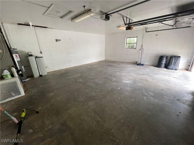 garage with a garage door opener and electric water heater