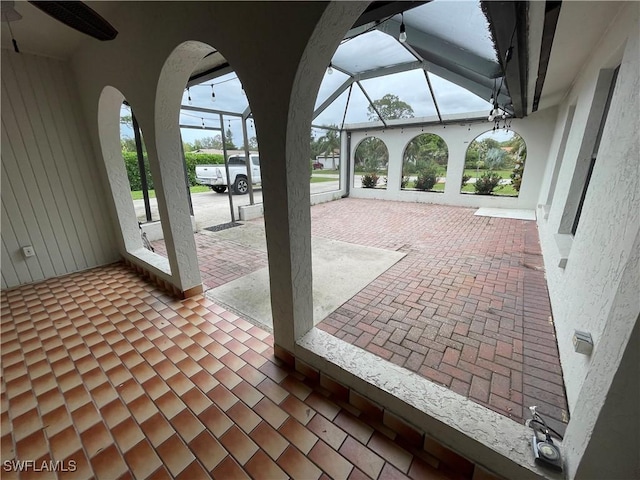 view of patio / terrace featuring glass enclosure