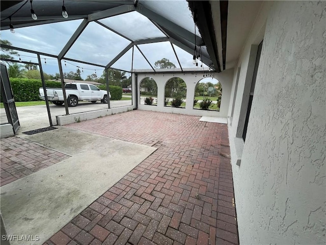 view of patio with glass enclosure