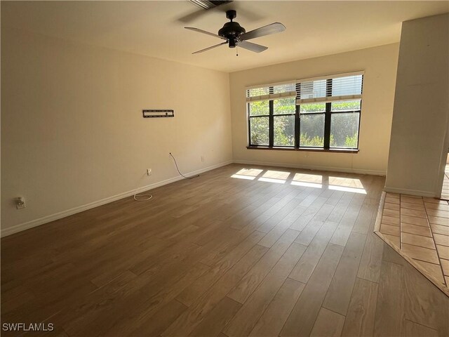 spare room with hardwood / wood-style flooring and ceiling fan