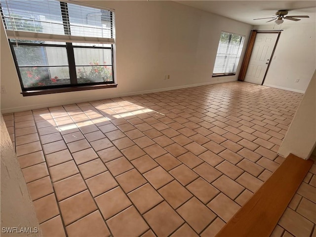 empty room with light tile patterned floors and ceiling fan