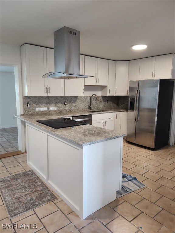 9882 Connecticut St, Bonita Springs, FL 34135 - kitchen featuring island range hood, stainless steel refrigerator with ice dispenser, a sink, and backsplash