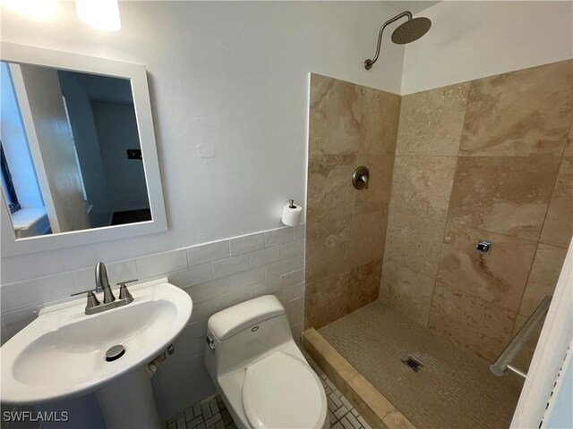 9882 Connecticut St, Bonita Springs, FL 34135 - full bath with tile walls, toilet, a sink, and a tile shower