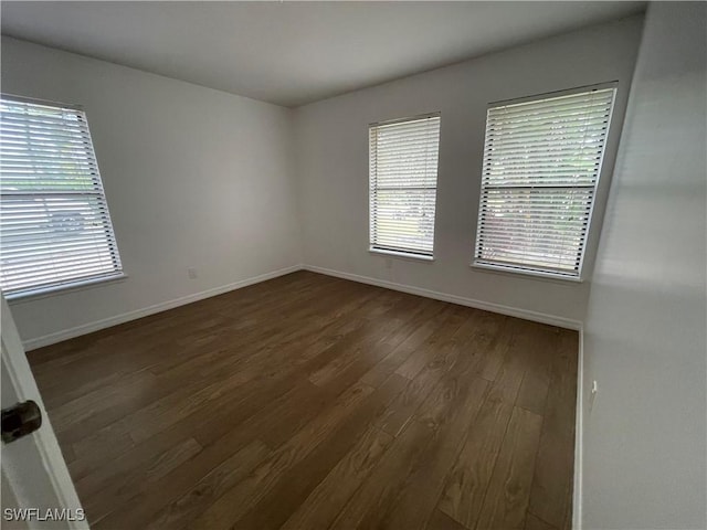 9882 Connecticut St, Bonita Springs, FL 34135 - spare room featuring baseboards and dark wood-type flooring
